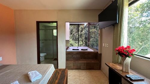 a bathroom with a shower and a bath tub at Macaco Prosa in Macacos