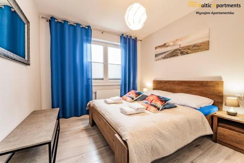 En eller flere senge i et værelse på Baltic Apartments - Apartamenty Bałtyk