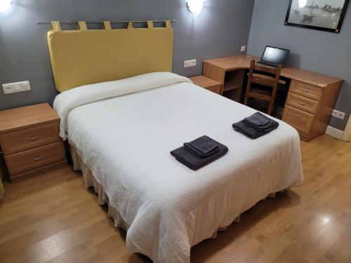 1 dormitorio con 1 cama con 2 toallas en TXIKI en Bermeo