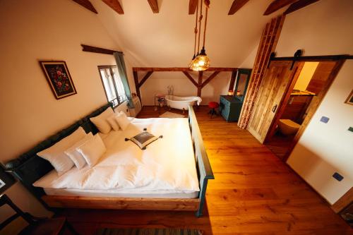 a bedroom with a large bed in a room at Slovenska Koliba 194 in Mădăraş