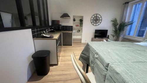 een keuken en een woonkamer met een tafel en een aanrecht bij ARQUEBUSE proche gare in Dijon
