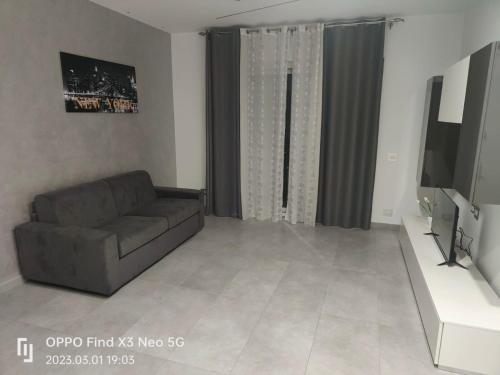 a living room with a couch and a flat screen tv at La Casa Di Lilla in Tortoreto Lido
