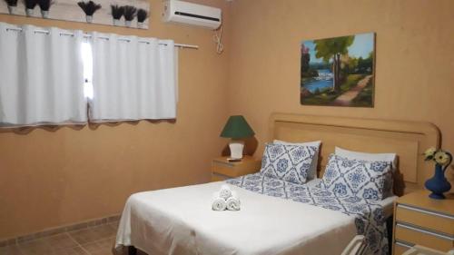 a bedroom with two beds with blue and white pillows at Hotel Fazenda Terra Ramos in Papucaia