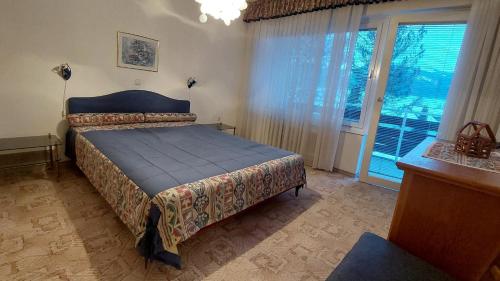 a bedroom with a bed and a large window at Sonnenalm apartments in Bad Mitterndorf