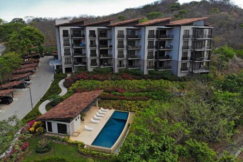 an aerial view of a resort with a swimming pool at Roble Sabana 404 Luxury Apartment Adults Only - Reserva Conchal in Playa Conchal