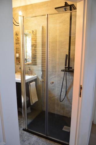 a shower with a glass door in a bathroom at Casa da Várzea - O Castelo à Janela!!! in Óbidos