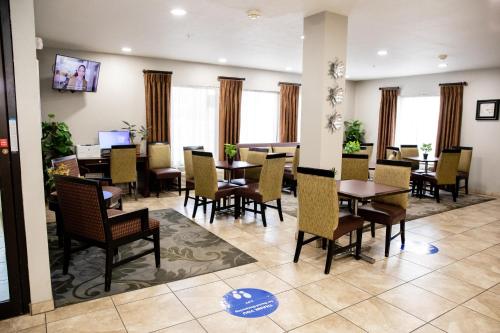 a dining room with tables and chairs and windows at Carpenter Street Hotel in Springfield