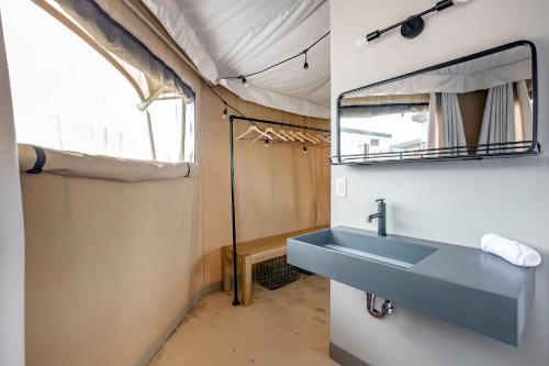 a bathroom with a sink and a mirror at Zion Wildflower Resort in Virgin