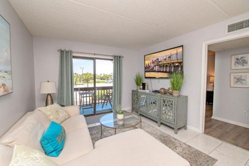 a living room with a white couch and a table at 4205 Courtyard Villa 2nd Fl N in Saint Augustine Beach