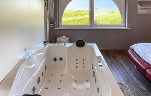 a white bath tub in a room with a window at Awesome Home In Diksmuide With Wifi in Diksmuide