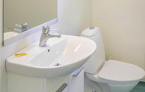 a white bathroom with a sink and a toilet at Stunning Home In Vimmerby With Wifi in Vimmerby