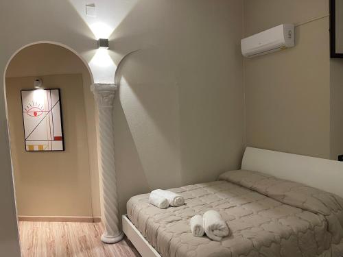 a bedroom with a bed and an archway with at Mazzini Apartment in Cosenza