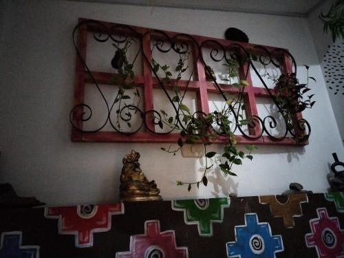 a window with a red frame and flowers on a wall at ECO ART Best view Machu Picchu in Machu Picchu