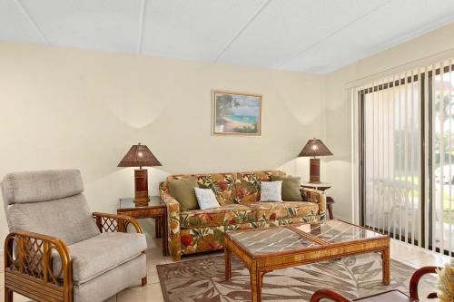 a living room with a couch and a chair at Unit 2105 - Ocean & Racquet Resort in Saint Augustine Beach