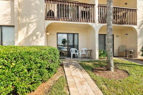 a house with a balcony and a table and chairs at Unit 2105 - Ocean & Racquet Resort in Saint Augustine Beach