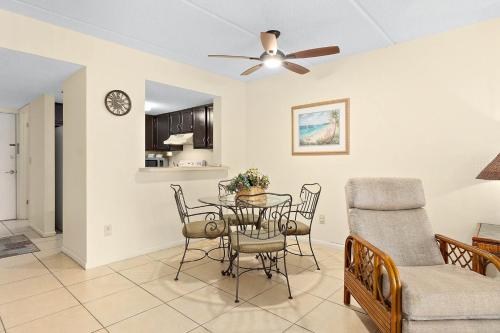 a dining room and living room with a table and chairs at Unit 2105 - Ocean & Racquet Resort in Saint Augustine Beach