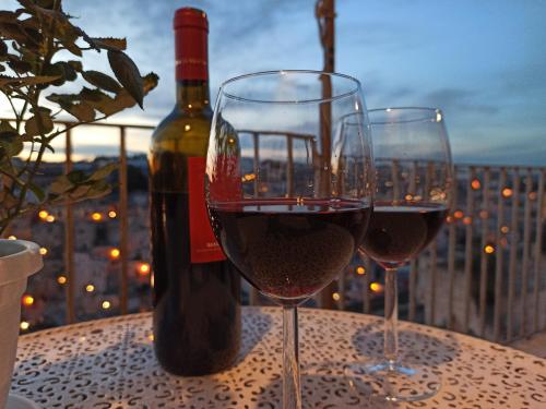 マテーラにあるRiscatto 1514のワイン1本とテーブル上のワイン2杯