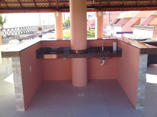 a reception counter in a resort with columns at Cumbuco Ocean View in Cumbuco