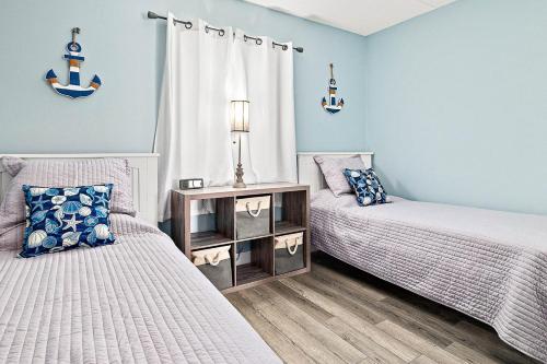 a bedroom with two beds and a table at Welcome to paradise unit 2201 in Saint Augustine Beach