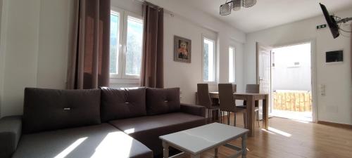 a living room with a couch and a table at Evergreen Thassos in Skala Potamias