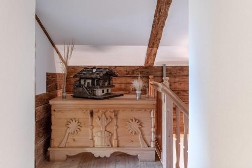 a stairway with a wooden staircase with a house on it at Chalet Laugenblick in Santa Valburga St. Walburg