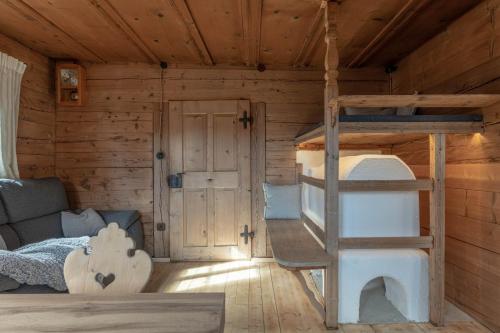 a bedroom with a bunk bed in a cabin at Chalet Laugenblick in Santa Valburga St. Walburg