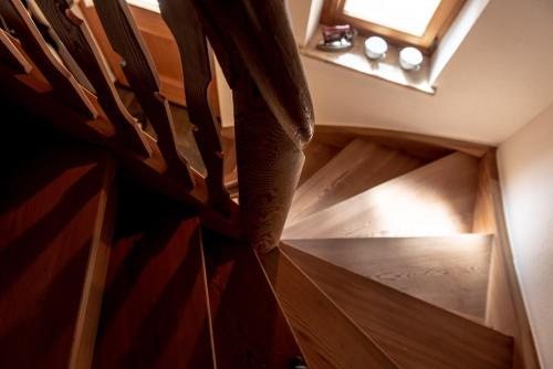 a wooden staircase in a room with a window at Chalet Laugenblick in Santa Valburga St. Walburg