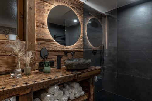 a bathroom with a sink and a mirror at Chalet Laugenblick in Santa Valburga St. Walburg