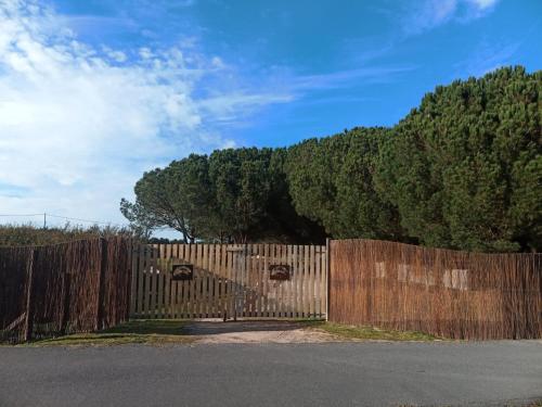 a wooden fence with a gate in front of a mountain at Pine 3 Inn, holiday home, activities and more in Boavista dos Pinheiros