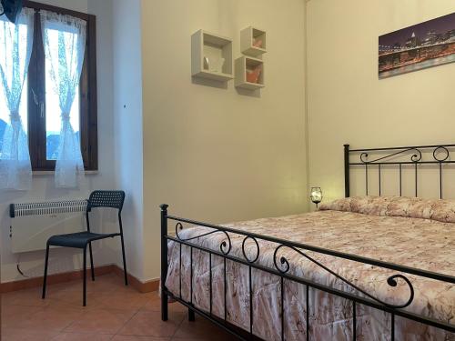 a bedroom with a bed and a chair and a window at Casalino 