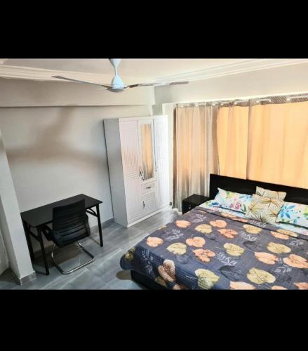 a bedroom with a bed and a desk in it at Ad apartment in Kwedonu