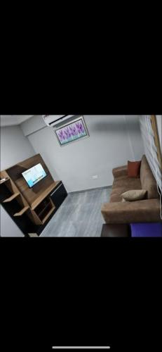 a living room with a couch and a table at Ad apartment in Kwedonu