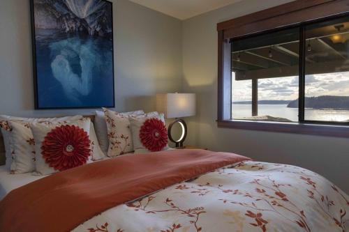 a bedroom with a bed with red flowers on it at 180º Puget Sound View in Fox Island