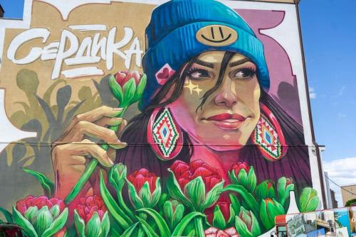 a mural of a woman with flowers on the side of a building at Cozy 2-Bedroom Flat in the very Center of Sofia in Sofia