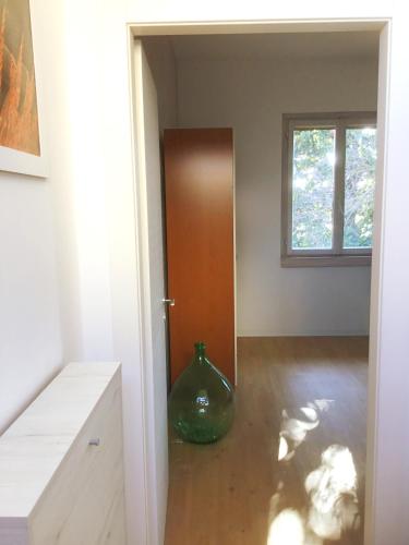 a room with a vase sitting on the floor next to a door at La Piracanta in Mantova