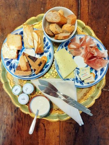 a table topped with plates of bread and cheese at La Piracanta in Mantova