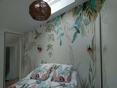a bedroom with a bed with a bird wallpaper at Nice family house in Hendaye