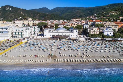 a view of a beach with chairs and umbrellas at Hotel Premuda in Spotorno