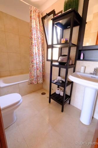 a bathroom with a toilet and a sink at Tenerife lizards - duplex in the first line in Callao Salvaje