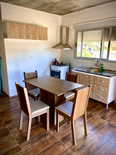 a kitchen with a large wooden table and chairs at Casa pet friendly, se reserva con seña in Piriápolis