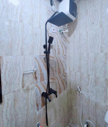 a shower head in the corner of a bathroom at Homey 2-Bed-Apt 24HRS POWER & Unlimited Internet Access in Lagos