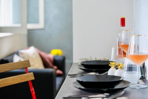 a table with two glasses of wine on it at Cozy 1-Bedroom flat in the very Center of Sofia in Sofia