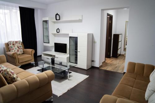 a living room with two couches and a television at Ultracentral Golden Apartament 2 in Suceava