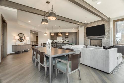 a dining room and living room with a table and chairs at Stein Eriksen Residences in Park City