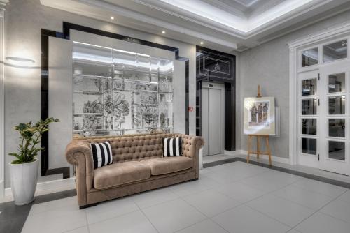 a living room with a couch and a window at Evita Hotel & SPA in Tleń