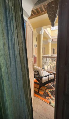 a view of a porch with a chair on a balcony at RIAD DAR NAOMI in Marrakech