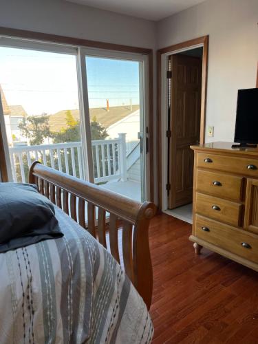 a bedroom with a bed and a view of the ocean at Shore house on Pelican Island! in Seaside Heights