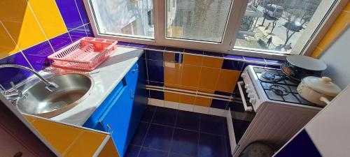 a small kitchen with a sink and a stove at Apartament Grigore Etaj 2 in Mangalia