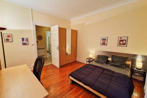 une chambre avec un lit et une table dedans dans l'établissement #EU Le 21 Dormoy, à Grenoble