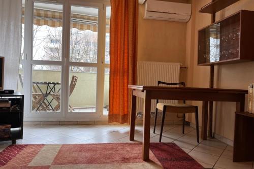 a living room with a table and a window at #EV Le Taillat T3 for 4 in Meylan with Terrace in Meylan